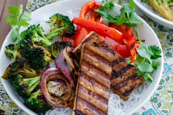 Smoky grilled tofu and broccoli atop noodles