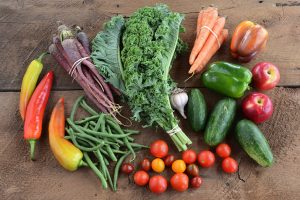 Abundance of fresh, colorful, local produce laid you on wood