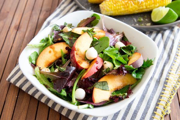Plate of Balsamic Peach Salad with lettuce and fresh mozzarella balls