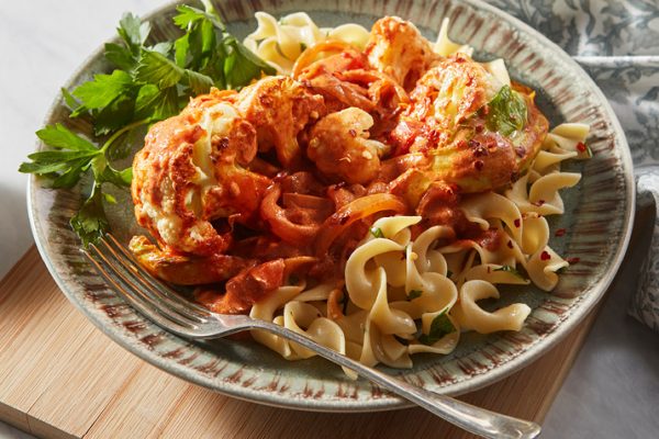 Cauliflower paprikash served over wavy egg noodles